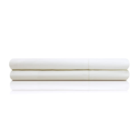 A Malouf Italian Collection sheet set placed on a white surface.