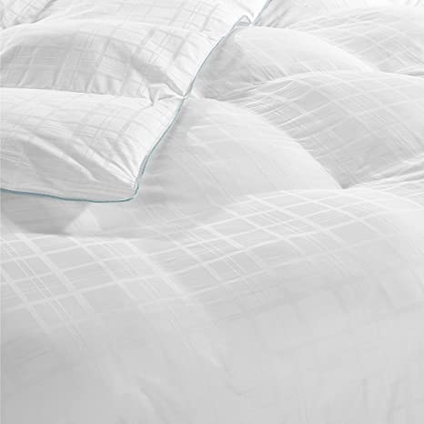 Crisp white duvet with a subtle checkered pattern and an aqua blue piping trim, neatly arranged on a bed, featuring CoolFx™ Down Alternative Fill, evoking a serene and clean Live Comfortably Cooling Cameron Tartan Comforter by Hollander.