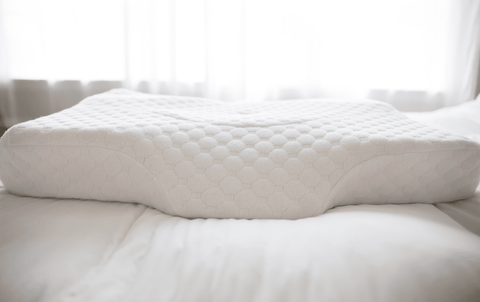 A Opulence Cervical Memory Foam Pillow sits atop the bed, providing comfort and support.