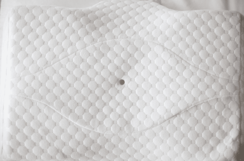 A white Opulence Cervical Memory Foam Pillow with a hole in it perfect for Memory Foam Pillow lovers.