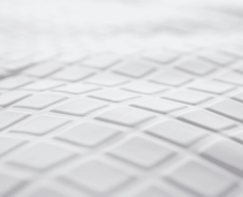A close up of a white sheet with squares on it, suitable for adult use: Final Sale Opulence Glacier Blanket by Opulence.