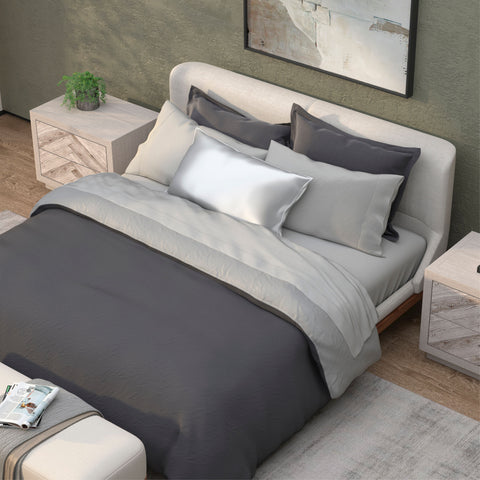 A modern, neatly-made bed with gray and white PureCare Soft Touch Bamboo duvet cover in a cozy bedroom with wooden nightstands and a minimalist painting hanging above.