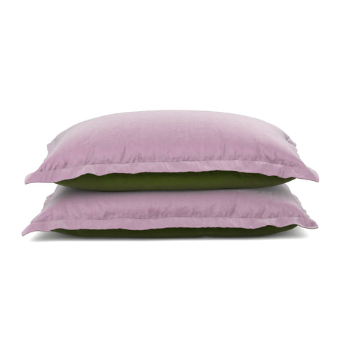 Two stacked pillows with light purple PureCare Cooling Bamboo pillow shams on a white background, the upper one resting slightly askew on the lower green pillow.