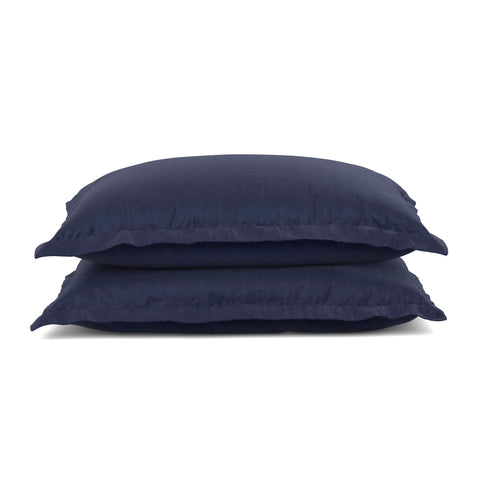 Two stacked navy blue PureCare Pillow Sham Set with a soft touch and flanged edges, isolated on a white background, illustrate comfortable and stylish bedding accessories made from Bamboo Rayon.