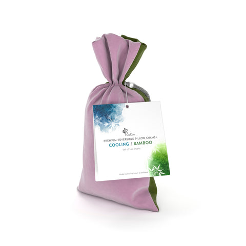 A lilac-colored fabric gift bag with a PureCare Pillow Sham Set | Cooling Bamboo label attached by a silver ribbon indicates a cooling, bamboo fabric product, suggesting eco-friendliness and comfort.