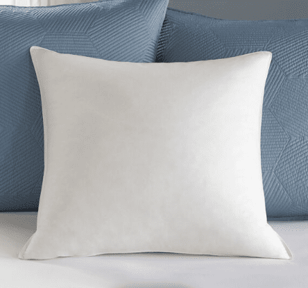 A white Keeco Pacific Coast Feather Pillow Insert | Euro Square 26" on a blue bed.