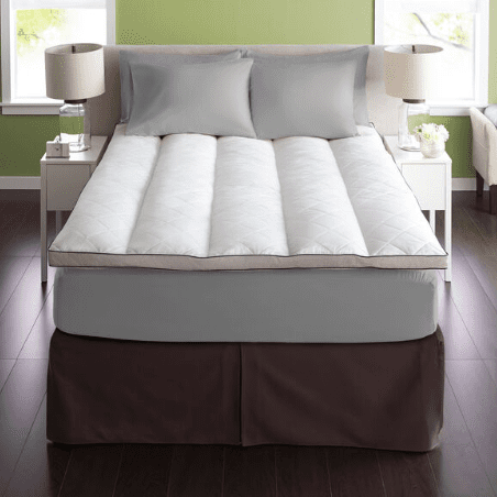 A bed with a Pacific Coast Feather Baffle Channel Euro Rest Feather Bed from Pacific Coast Feather Company on top of it.