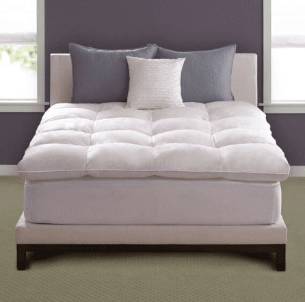 A bed with a Pacific Coast Feather Company® Luxe Loft Deluxe Baffle Box Featherbeds on top of it.