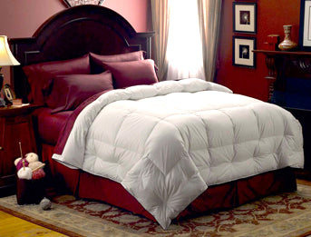 A Pacific Coast Feather Company comforter on a bed provides warmth and comfort.