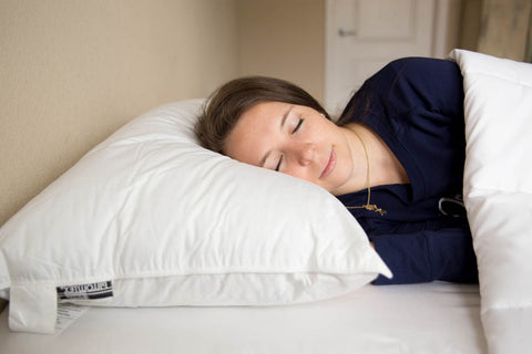 A woman peacefully sleeping on a Pillowtex Premium Polyester Pillow.