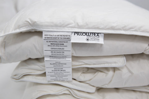 A stack of Pillowtex High End Down Comforters.