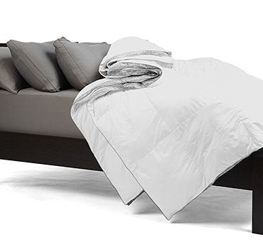 A bed with a white comforter and Sheex Final Sale: SHEEX Comforter | 600 Thread Count Cotton Cover | Twin Size pillows.