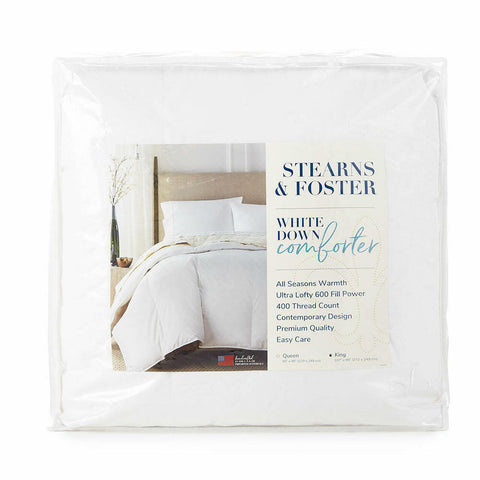 A Stearns & Foster White Down Comforter | All Season Warmth, 600 Fill Power, 400 Thread Count is neatly packaged in clear plastic. The label highlights its ultra lofty white duck down and easy-care features.
