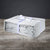 A neatly folded, soft gray Delilah Home "Final Sale: Organic Hemp Bed Sheet Collection" is tied with a white ribbon with purple circles and rests on wood before a dark gray background—luxurious bedding, ideal for gifting.