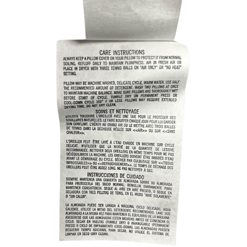 A machine-washable Carpenter Co. Beyond Down Synthetic Bed Pillow with instructions.
