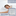 A woman is laying on a bed with the breathable Manchester Mills Envirosleep Dream Memories Memorelle Fiber Fill Pillow.