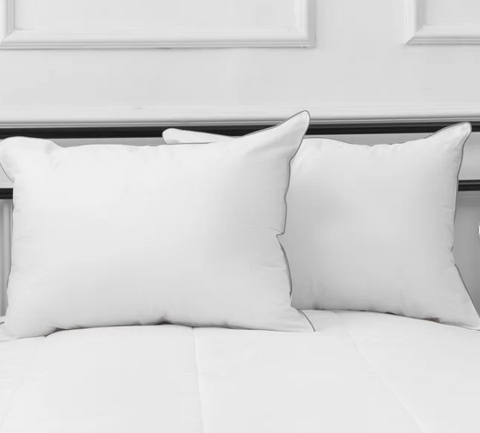 Two comfortable white Westin® Heavenly Soft Support Polyester pillows on top of a bed.
