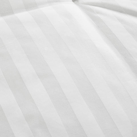 A close up image of a Live Comfortably White Duck Down Comforter with white stripes from Hollander.