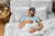 A man peacefully sleeping in bed with a blue eye mask and a Down Etc. Aquaplush Pillow | Firm.