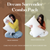 Two cross-legged women hug large white pillows for side sleepers. The left, in a yellow sweater and jeans, showcases the "Envirosleep Dream Surrender" with polyester clusters. The right, in a black top and jeans, holds the "Dream Surrender Firm." Text: "Dream Surrender Combo Pack by Manchester Mills.