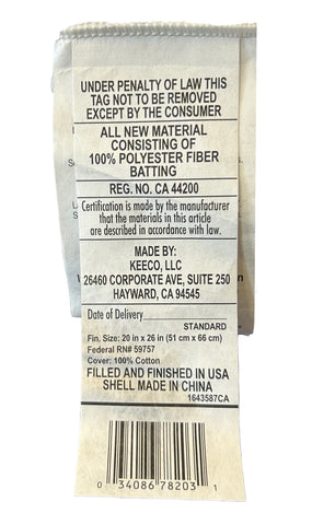 A crumpled Restful Nights clothing tag stating "under penalty of law this tag not to be removed except by the consumer," with information about the material composition, size, manufacturer location, and regulatory compliance codes of the Restful Nights Eco Endure Pillow | Polyester Medium-Firm.