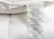 A close-up of the Pillowtex High End White Goose Down Pillow, featuring two tags: a Pillowtex brand tag and a larger one with materials and care info—perfect for side and back sleepers seeking medium-firm support.