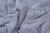 Close-up of the Herringbone Weave Blanket by American Blossom Linens, crafted from organic cotton in the USA. The blue and white chevron pattern and visible folds highlight its soft texture and heirloom-quality craftsmanship.