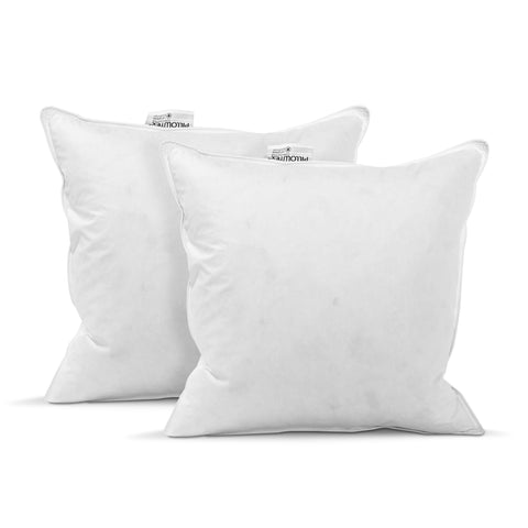 Two white, fluffy square Pillowtex Pillow Inserts with tags visible stand side by side against a white background, likely showcasing their plush softness and comfort especially designed for the hospitality industry.