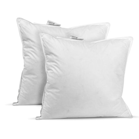Two fluffy white Pillowtex pillows with visible tags and machine washable Pillowtex White Duck Feather & Down pillow inserts stand against an all-white background, offering a clean and cozy bedding accessory concept for the hospitality industry.
