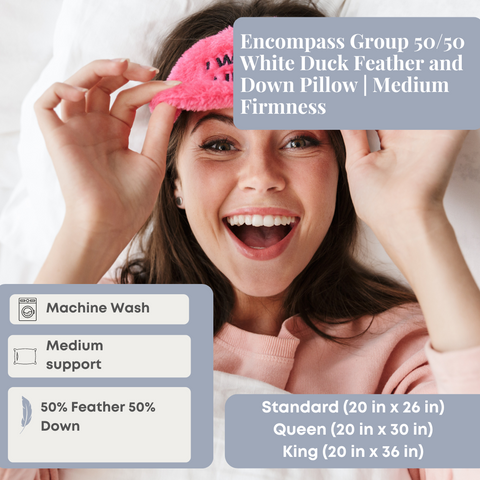 A cheerful woman lies on an Encompass Group 50/50 White Duck Feather and Down Pillow, holding a pink eye mask, with details about the pillow's material, washing instructions, and available sizes presented alongside.