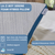 Close-up of a La-Z-Boy Serene Foam Hybrid Pillow in white and blue on a bed with a cream knit blanket. Overlays show features: moisture-wicking, removable washable cover, spot clean only, medium support, foam fill, 20x26" size.