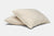 Two off-white, rectangular American Made Wool Filled Pillows by American Blossom Linens are stacked on a white background. Featuring organic cotton covers and adjustable firmness, they appear soft, plush, and gently rounded at the edges.