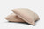 Two Colored Cotton Bed Pillowcases by American Blossom Linens, made from natural heirloom cotton in the USA, are stacked on a plain light gray background. Their smooth, wrinkle-free covers offer a soft and inviting look.