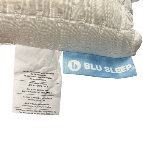 A close-up of two mattress labels on a white background. The first label states care instructions and material content for a Blu Sleep Prestige Coconut Memory Foam Pillow with a cooling cover pillow. The second label mentions compliance with California Proposition
