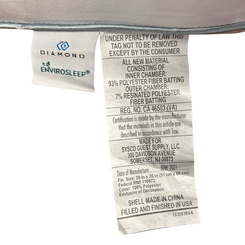 Close-up of a Envirosleep Diamond Support Gel Fiber Fill Pillow | Medium Support label showing information such as brand (Manchester Mills), materials (97% polystyrene fiber, supportive pillow), regulations ("under penalty of law this tag not to be removed").