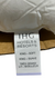 A white fabric label attached to a Holiday Inn<sup>®</sup> Soft Support Pillow | Blue Cord Polyester by Hollander for stomach and back sleepers displays the text "IHG Hotels & Resorts" at the top. Below, it reads "King - Soft" and "King - Suave." At the bottom, it includes the French translation: "Très Grand Lit - Moelleux." The label is partially lifted off cardboard.