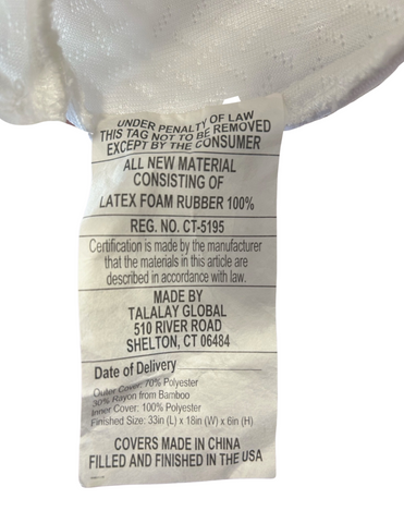 A label on a Latex International Rejuvenite Classic Low Profile Pillow showing material composition: 100% Talalay latex rubber foam, with certifications and the manufacturer's address in Tolland, Connecticut, and care instructions indicating a.