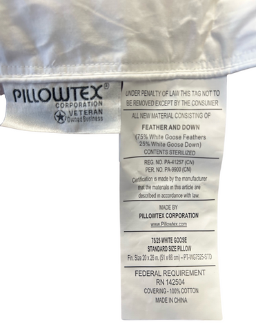 A close-up view of a Pillowtex White Goose Down & Feather Pillow label detailing materials—75% white goose feathers, 25% white goose down—and compliance with lawful certification, with a sturdy 100% cotton cover.