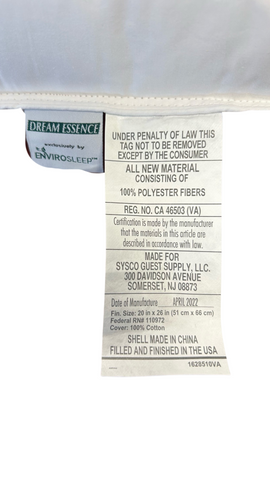 Close-up of a Dream Essence Down Alternative Pillow label from Sysco Guest Supply, showing material details, regulatory compliance, and origin information, including "made in China" and filling consisting of 100% polyester fibers.