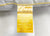 A close-up of the JS Fiber Super Gold Choice Pillow | Heavyweight by JS Fiber shows a white pillow with a yellow-ombre tag, featuring siliconized fiberfill for side sleepers—resilient, soft, lofty, comfortable, and non-allergenic.