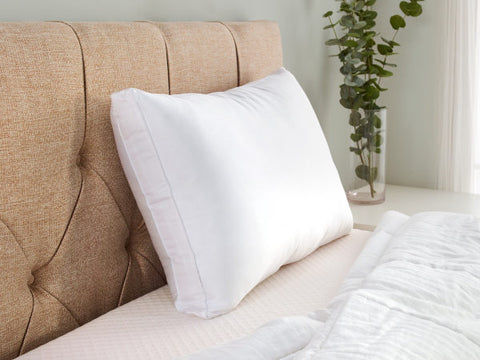 A Carpenter Co. Dual Layered Comfort Pillow on a bed in a bedroom, perfect for side sleepers.