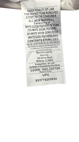 A care label indicating that the item is made of 100% cotton with Down Etc. Rhapsody Wrap Duck Feather & Down, machine washable, and made in the USA, with the RN and CA identification numbers listed.
