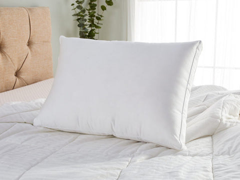 A Carpenter Co. Dual Layered Comfort Pillow | Extra-Firm Support on the bed for a side sleeper.