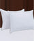 Two Beautyrest Won't Go Flat Pillows providing medium support on the bed.