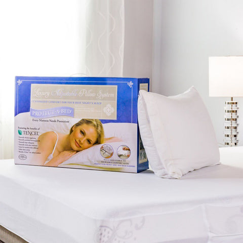 A woman is laying on a bed with a Protect-A-Bed Adjustable Fill Luxury Waterproof Tencel Lyocell Pillow.