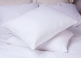 Two Restful Nights Ultra Essence Pillows, perfect for restful nights, sit atop the bed.