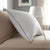 A Pacific Coast Feather Grand Embrace® Pillow is resting on a bed.