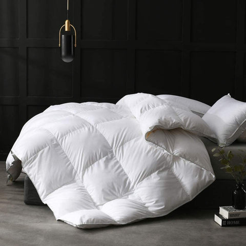 A luxurious Pillow Factory 100% White Duck Down Duvet Insert on a black bed.