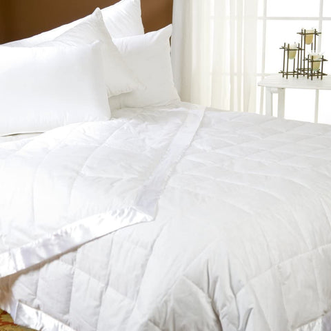 A Pacific Coast Feather Company white cotton comforter on the bed in a bedroom.