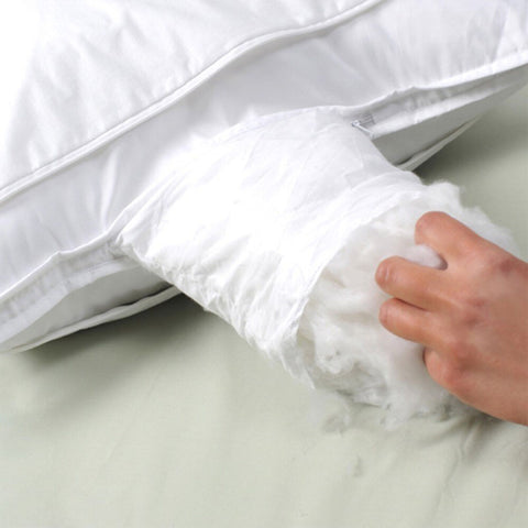 A person is adjusting a Protect-A-Bed Adjustable Fill Luxury Waterproof Tencel Lyocell Pillow.